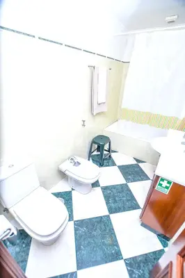 a bathroom with two toilets and a checkered floor at Authentic House in Funchal + City View in Funchal