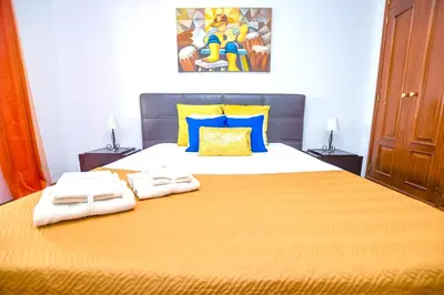 a bedroom with a large bed with towels on it at Authentic House in Funchal + City View in Funchal