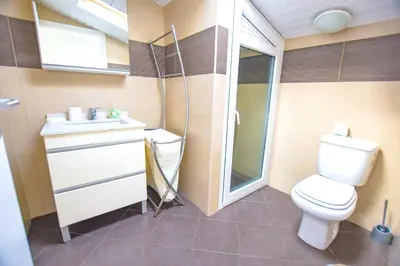 a small bathroom with a toilet and a sink at Authentic House in Funchal + City View in Funchal