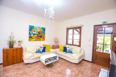 a living room with two couches and a chandelier at Authentic House in Funchal + City View in Funchal