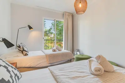 a bedroom with two beds and a window at Elena Apartment by Atlantic Holiday in Funchal