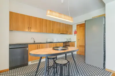 a kitchen with wooden cabinets and a wooden table at Elena Apartment by Atlantic Holiday in Funchal