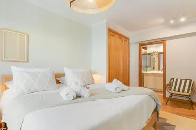 a bedroom with a large white bed with towels on it at Elena Apartment by Atlantic Holiday in Funchal