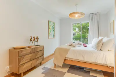 a bedroom with a bed with a dresser and a window at Elena Apartment by Atlantic Holiday in Funchal
