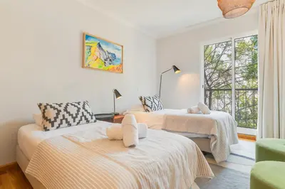 a living room with two beds and a window at Elena Apartment by Atlantic Holiday in Funchal