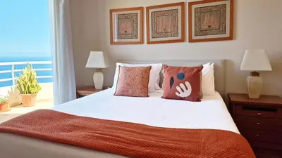 a bedroom with a bed with pillows and a balcony at The Atlantic Lookout by LovelyStay in Caniço
