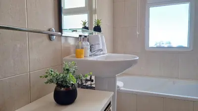 a bathroom with a sink and a toilet and a tub at The Atlantic Lookout by LovelyStay in Caniço