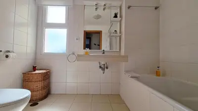 a white bathroom with a tub and a sink at The Atlantic Lookout by LovelyStay in Caniço