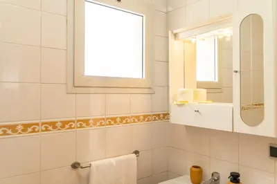 a bathroom with a sink and a mirror at Apartamento Pedras Pretas in Porto Santo
