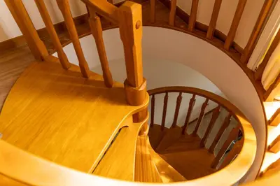 a wooden spiral staircase in a house at Apartamento Pedras Pretas in Porto Santo