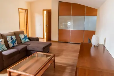 a living room with a couch and a coffee table at Apartamento Pedras Pretas in Porto Santo
