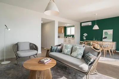 a living room with a couch and a table at Lido I by An Island Apart in Funchal