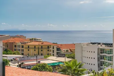a view of a city with the ocean in the background at Lido I by An Island Apart in Funchal