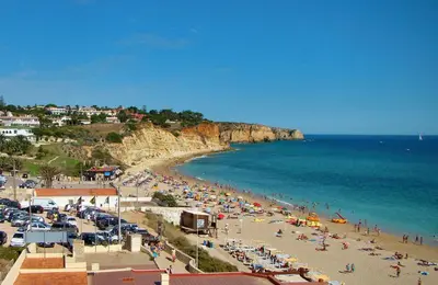 a beach with a crowd of people and the ocean at BUGANVÍLEA - Vivenda johanna in Lagos