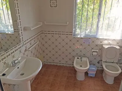 a bathroom with a sink and a toilet and a bidet at BUGANVÍLEA - Vivenda johanna in Lagos