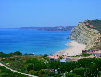 a view of a beach with people in the water at BUGANVÍLEA - Vivenda johanna in Lagos