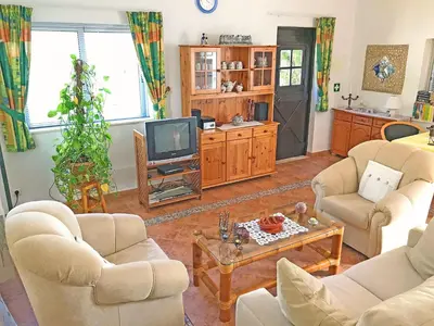 a living room with two couches and a tv at BUGANVÍLEA - Vivenda johanna in Lagos