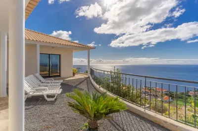 a house with a balcony with a view of the ocean at Ocean View Tabua by Holiday Rental Madeira in Ribeira Brava