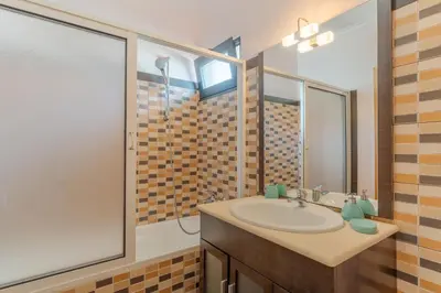 a bathroom with a sink and a mirror at Ocean View Tabua by Holiday Rental Madeira in Ribeira Brava