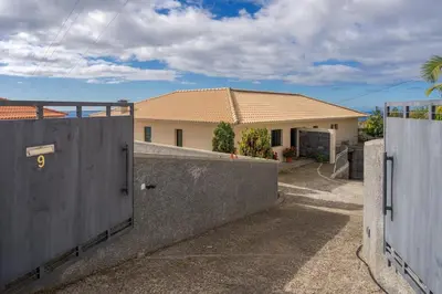 a house with a gate and a fence at Ocean View Tabua by Holiday Rental Madeira in Ribeira Brava