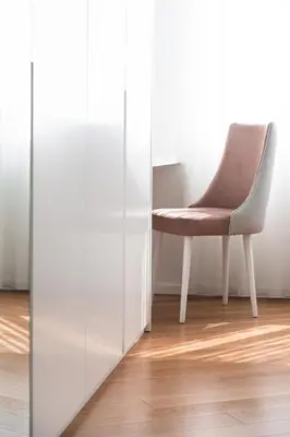 a chair in a room next to a glass wall at Banana Lodge by Atlantic Holiday in Funchal