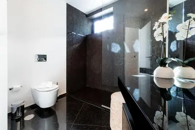 a bathroom with a toilet and a glass shower at Banana Lodge by Atlantic Holiday in Funchal
