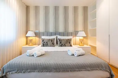 a bedroom with a large bed with two lamps at Banana Lodge by Atlantic Holiday in Funchal