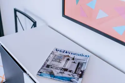 a magazine sitting on a table next to a lamp at La Madérene with Pool by Stay Madeira Island in Tábua