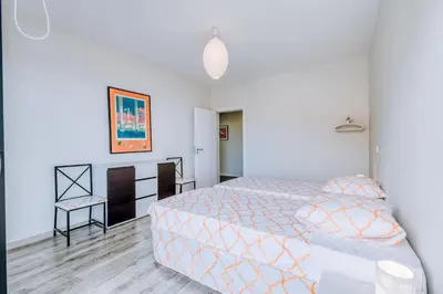 a bedroom with a bed and a table and a chair at La Madérene with Pool by Stay Madeira Island in Tábua