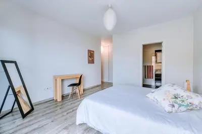 a white bedroom with a bed and a table at La Madérene with Pool by Stay Madeira Island in Tábua