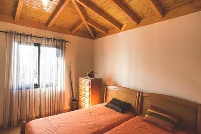 a bedroom with a bed and a window at Casa da Caixeira in Arco da Calheta
