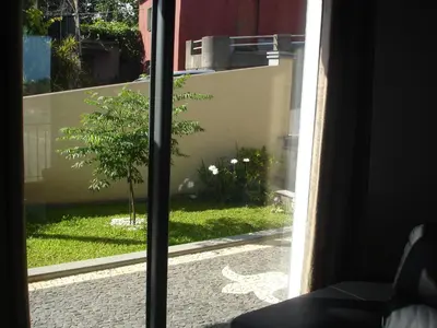 a view of a garden from a window at Casa da Caixeira in Arco da Calheta