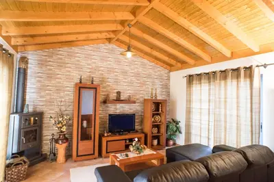 a living room with a couch and a fireplace at Casa da Caixeira in Arco da Calheta