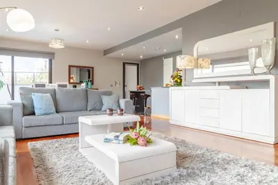 a living room with a couch and a table at Villa Serramar in Estreito da Calheta