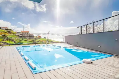 a large swimming pool on top of a building at Villa Serramar in Estreito da Calheta