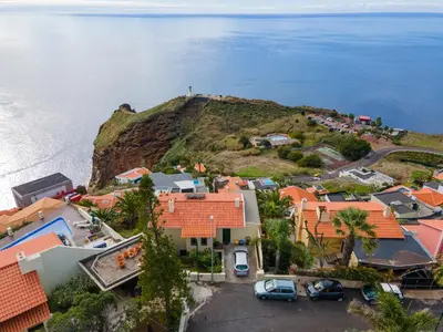 an aerial view of a small village on the coast at Garajau House - Sunrise to Sunset Ocean View Villa in Caniço