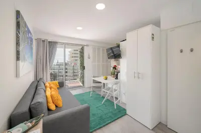 a living room with a gray couch and a table at Funchal Sea View I by An Island Apart in Funchal