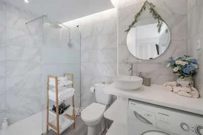 a bathroom with a toilet and a sink and a mirror at Funchal Sea View I by An Island Apart in Funchal