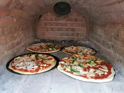 three pizzas in a brick oven with four pizzas at Casa Atlantico Suite in Ribeira Brava