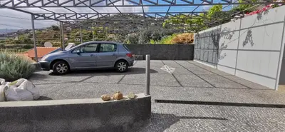 a small car parked in a parking lot at Casa Atlantico Suite in Ribeira Brava