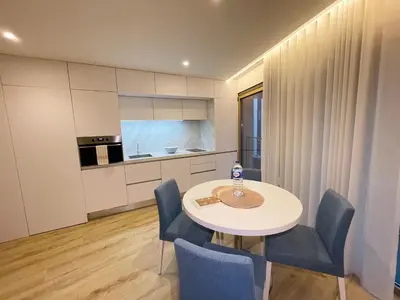 a kitchen with a table and chairs in a room at Hortas Residence 13 in Funchal