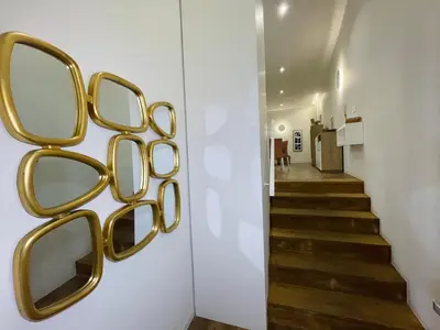a hallway with gold framed mirrors on the wall at Hortas Residence 13 in Funchal