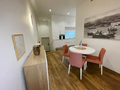 a kitchen and dining room with a table and chairs at Hortas Residence 13 in Funchal