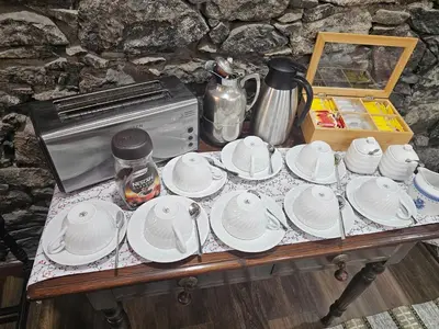 a table topped with white plates on top of it at Casa Das Videiras in Seixal