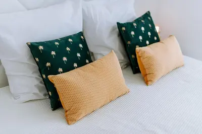 three pillows sitting on top of a bed at Casa das Voltinhas in Ponta do Sol