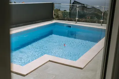 a swimming pool in the middle of a house at Casa das Voltinhas in Ponta do Sol