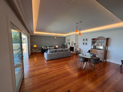 a living room with a couch and a table at Casa Roc Madeira - 5 Bedrooms - Ocean and City Views - Private Heated Pool in Funchal