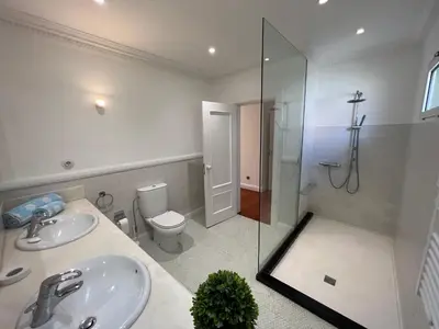 a bathroom with a sink and a shower and a toilet at Casa Roc Madeira - 5 Bedrooms - Ocean and City Views - Private Heated Pool in Funchal