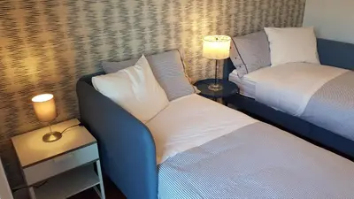 a bedroom with a bed and a couch and a lamp at Casa Roc Madeira - 5 Bedrooms - Ocean and City Views - Private Heated Pool in Funchal