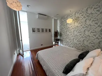 a bedroom with a bed and a large window at Casa Roc Madeira - 5 Bedrooms - Ocean and City Views - Private Heated Pool in Funchal